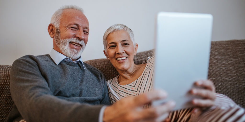 Old Couple on iPad sitting on couch